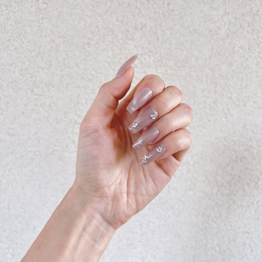 elegant nude nails with sparkle detail
